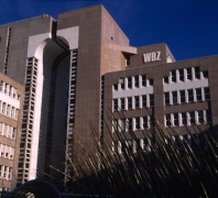 Außenansicht des WBZ in Düsseldorf. Ein hoher Bau mit einer weiß braunen Fassade und vielen Fenstern.